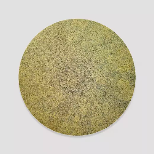 Extra fine gold scribble filling a black circle